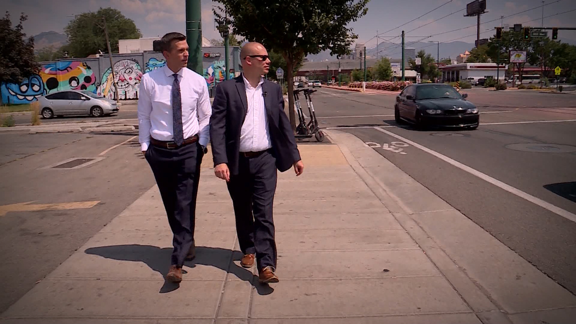 Mike Headrick walks with Nigel Swaby, who lives near the Gateway Inn.