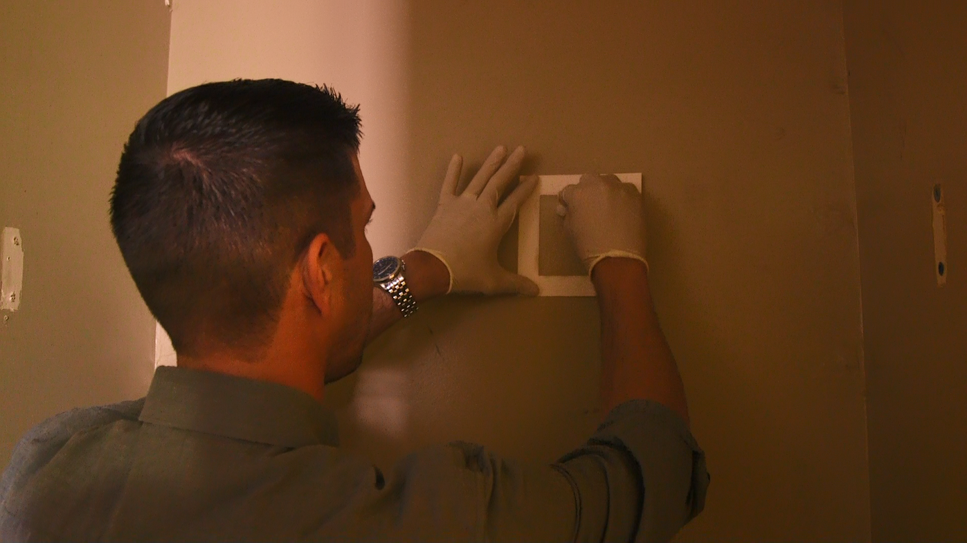 Jonathan Brockbank, a certified home inspector, does a meth test in a room at the Gateway Inn.