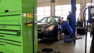 Mechanics work on a car at Matson Auto & Marine Service in Riverton, Utah.