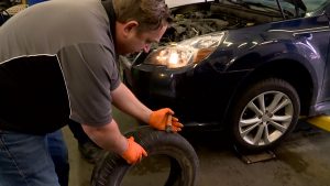 Mike Matson, owner of Matson Auto & Marine, demonstrates an unsafe tire.