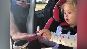 Braelyn painting one of the firefighter's nails.