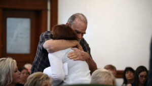 Larry Woodcock embraces Kay Woodcock during the sentencing hearing of Lori Vallow Daybell. (Pool)