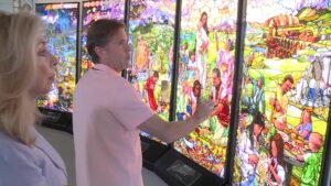 Tom Holdman showing the "Seven Pillars of Humanity." KSL's Carole Mikita. (KSL TV)
