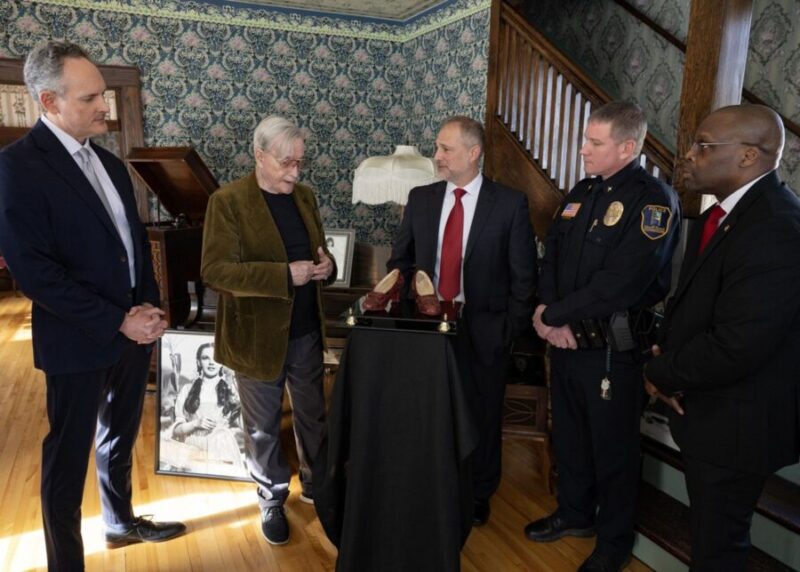 Michael Shaw is pictured being reunited with the slippers he owned for the first time since they were stolen in 2005. FBI agents discovered the shoes in a 2018 sting operation and sent them to the Smithsonian to confirm their authenticity. (FBI Minneapolis)