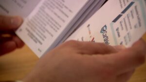 Matt Gephardt looking at the CarShield documents. (KSL TV)
