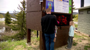 Visitors grabbing life jackets at the loaner station. (Eddie Collins, KSL TV)