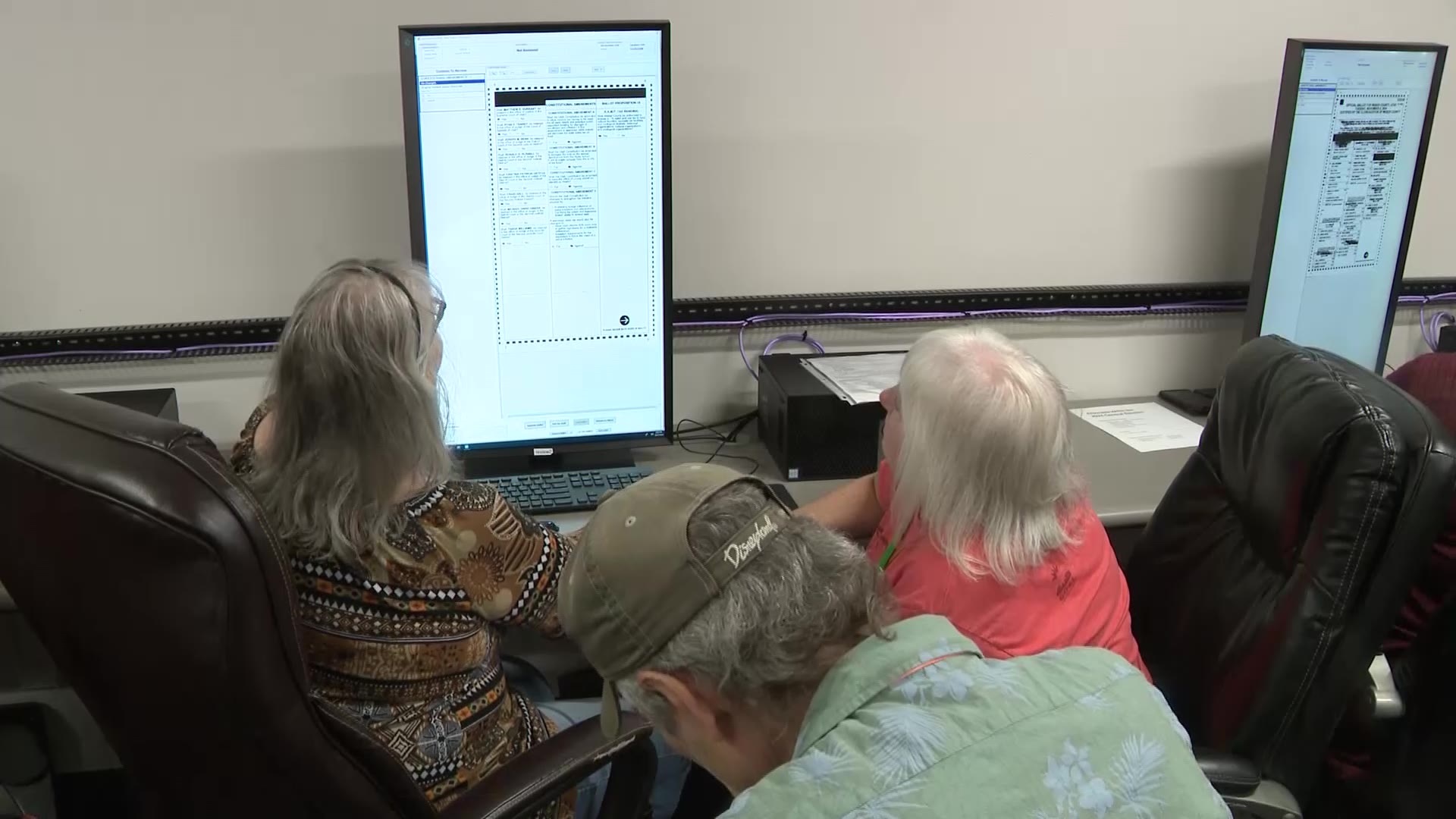 A team of three poll workers reviewing a ballot over its voters' intent. (KSL TV)