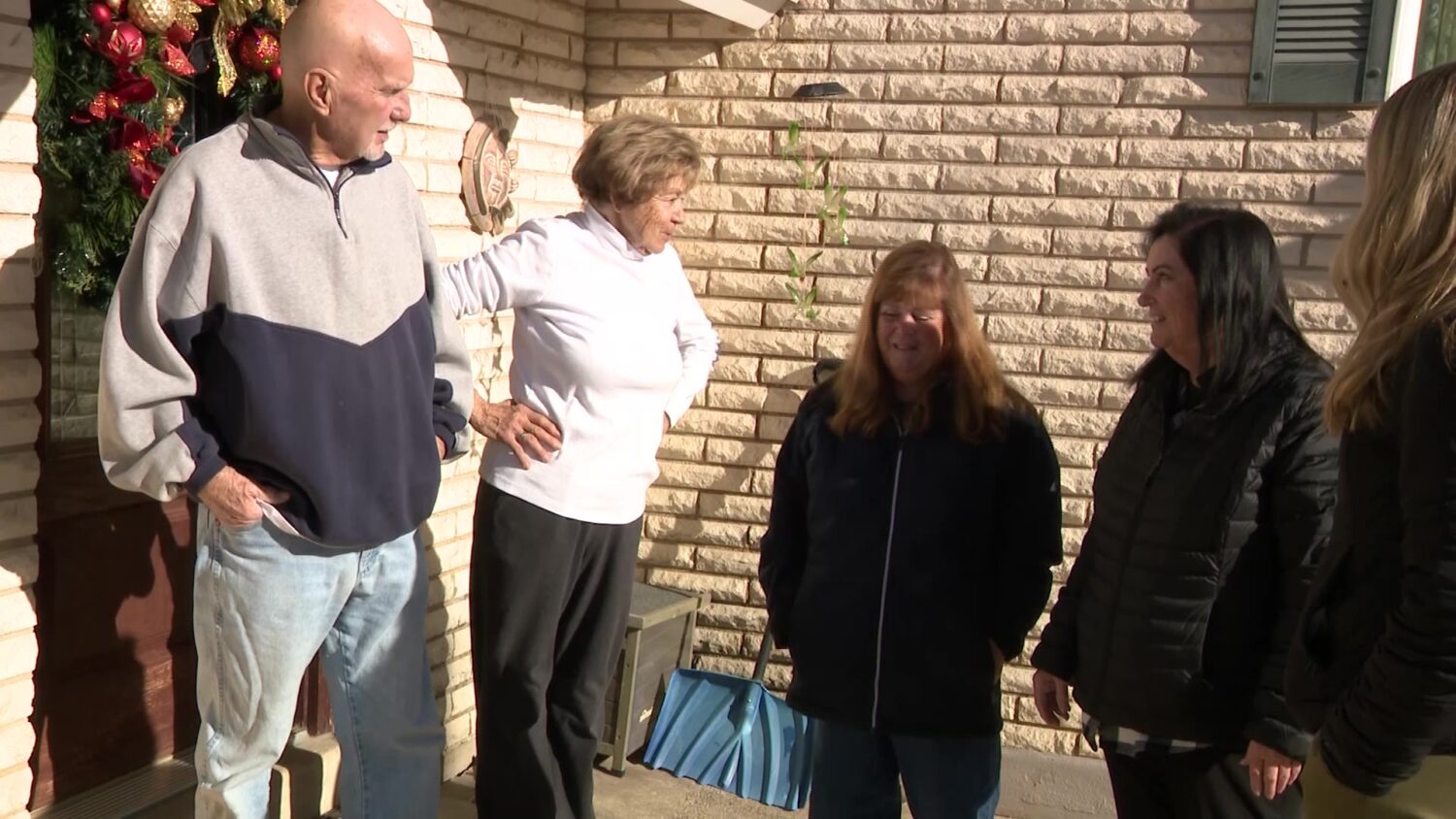 Marianne Peterson outside her home with Cathy and Carol Stoker, who came to deliver Peterson fresh water. (KSL TV)