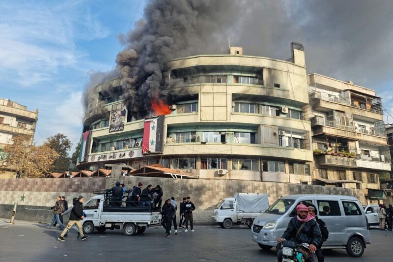 Flames sweep through the criminal security branch of Syria's Interior Ministry in Damascus on December 8 after rebels declared they have taken the Syrian capital in a lightning offensive. (Sam Hariri/AFP/Getty Images)