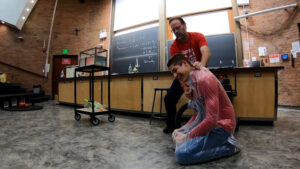 Beehler demonstrates atmospheric pressure by putting a student in a bag and evacuating the air. (Peter Rosen, KSL TV)