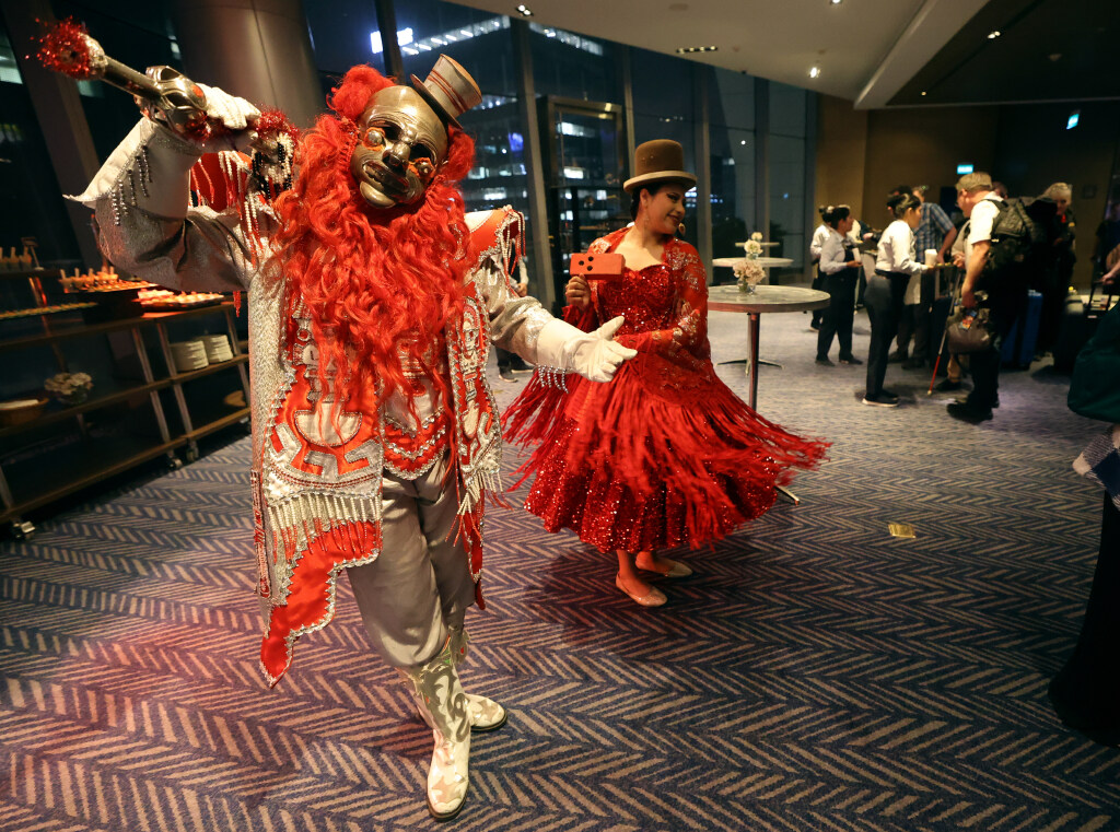 Performers pose and dance as members of The Tabernacle Choir and Orchestra at Temple Square check into The Westin Lima Hotel and Convention Center in Lima, Peru, for the “Songs of Hope” world tour on Tuesday, Feb. 18, 2025. (Kristin Murphy, Deseret News)