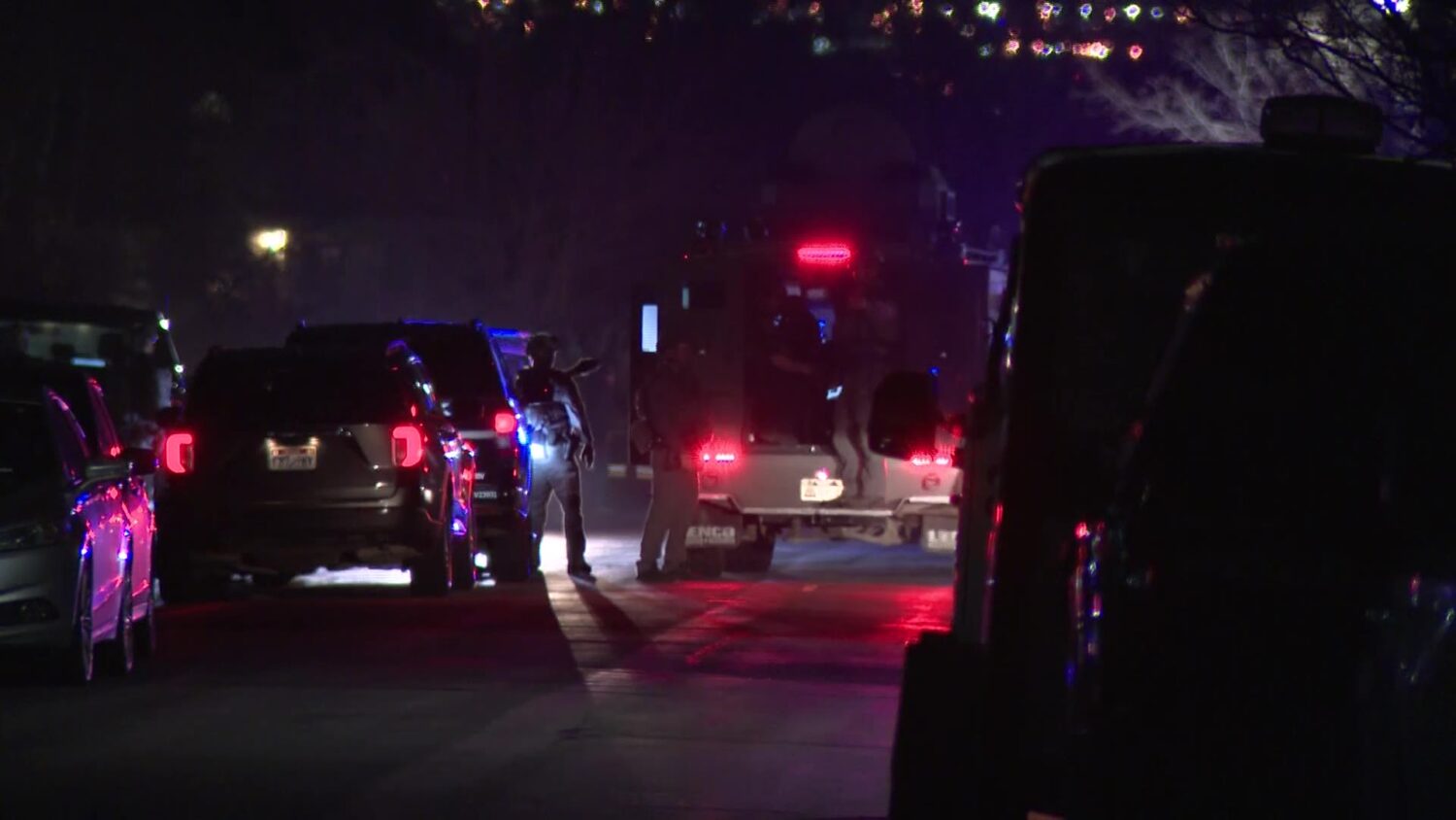 West Jordan SWAT outside of a home that four people ran into after allegedly fleeing from police Tuesday night, March 25, 2025. (Mark Less, KSL TV)