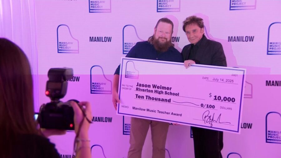 Jason Weimer, director of instrumental music at Riverton High School, was given an award by Barry Manilow, presented at a concert on Monday, July 14, 2025. (Nathan Riser, KSL TV)
