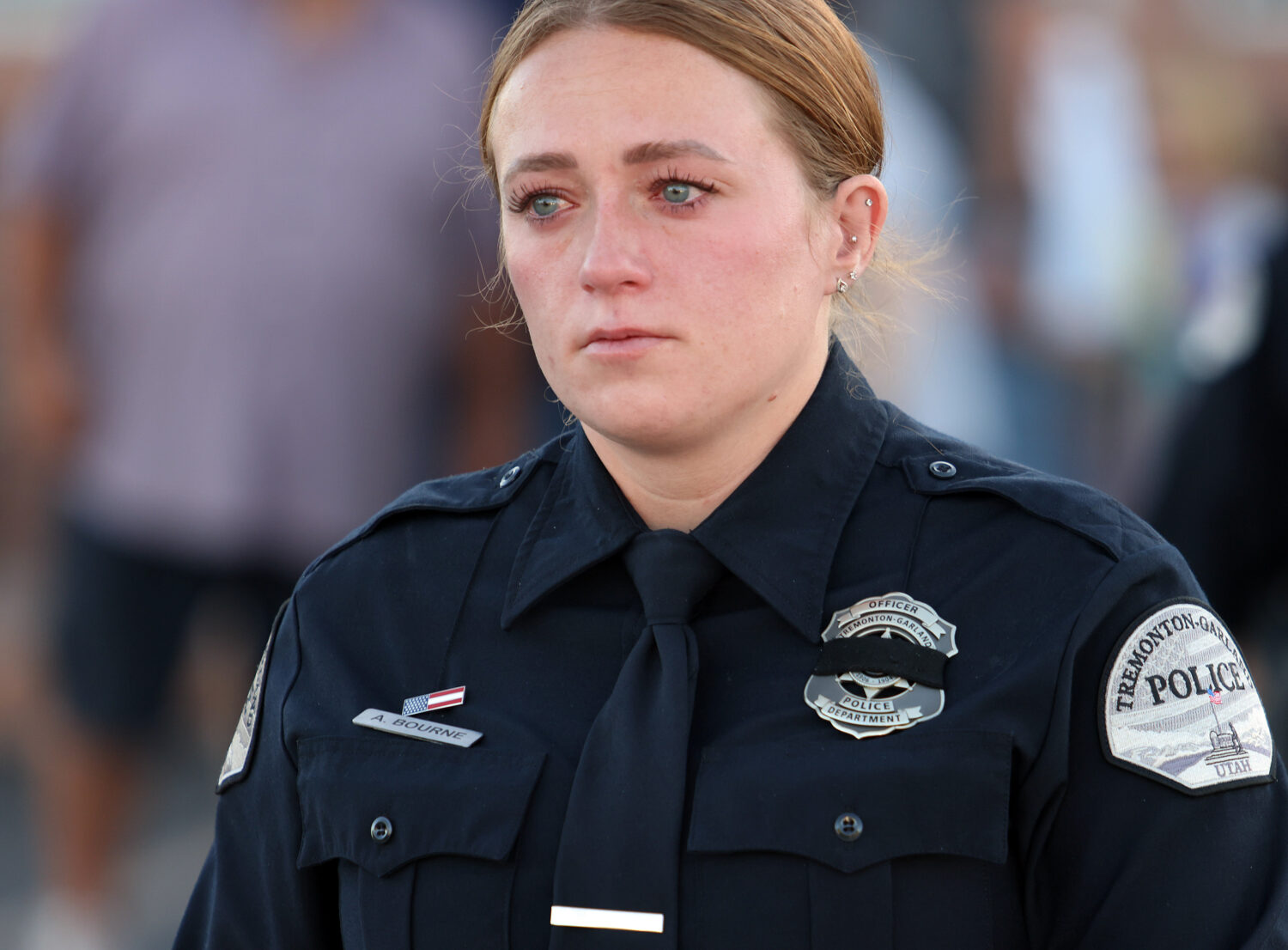 Officer Bourne of the Tremonton-Garland Police Department mourns the loss of her two fallen colleagues after escorting the casket of Sgt. Lee Sorensen to a funeral home on Main Street in Garland, Utah, Monday, Aug. 18, 2025. (Brian Nicholson, Deseret News)