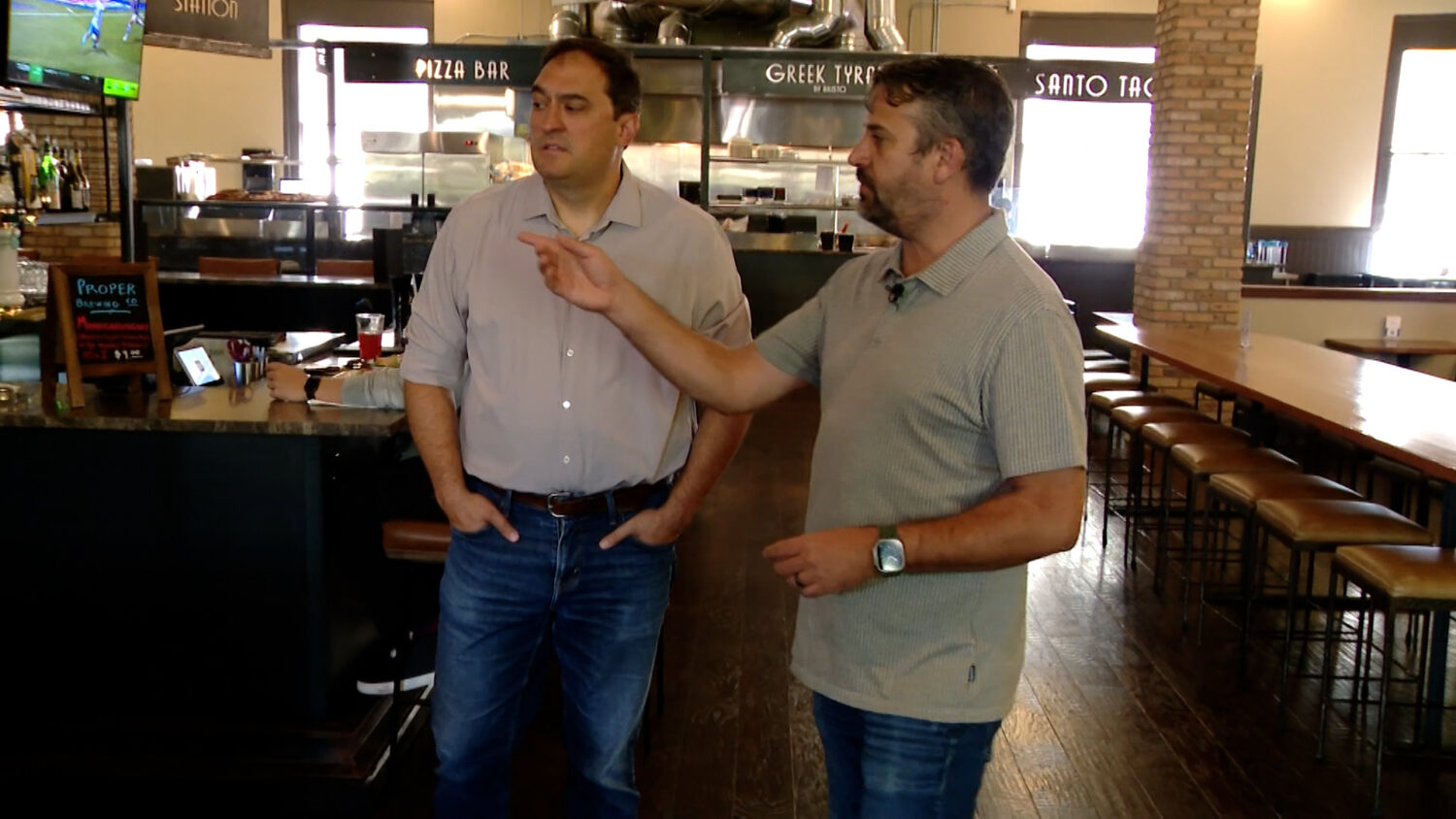 Sugar House Station owner Scott Evans shows KSL's Matt Gephardt how restaurant QR code ordering has helped his establishment. (Tanner Siegworth, KSL TV)