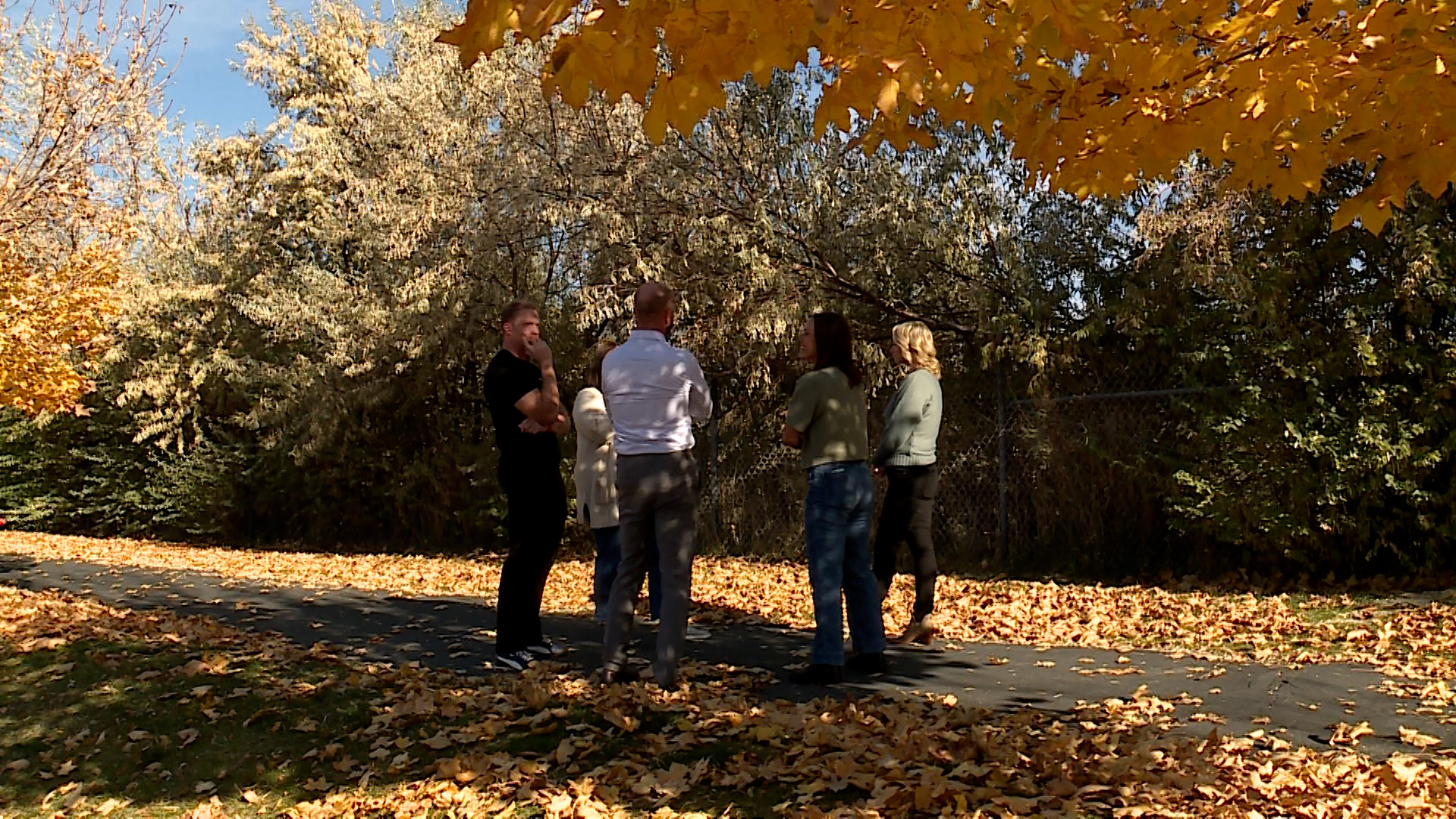 Residents of the Spring View Farms neighborhood in Bluffdale talk together on Thursday, Oct. 30, 2025 near the site of a planned FrontRunner station. (Jason Hammer, KSL TV)