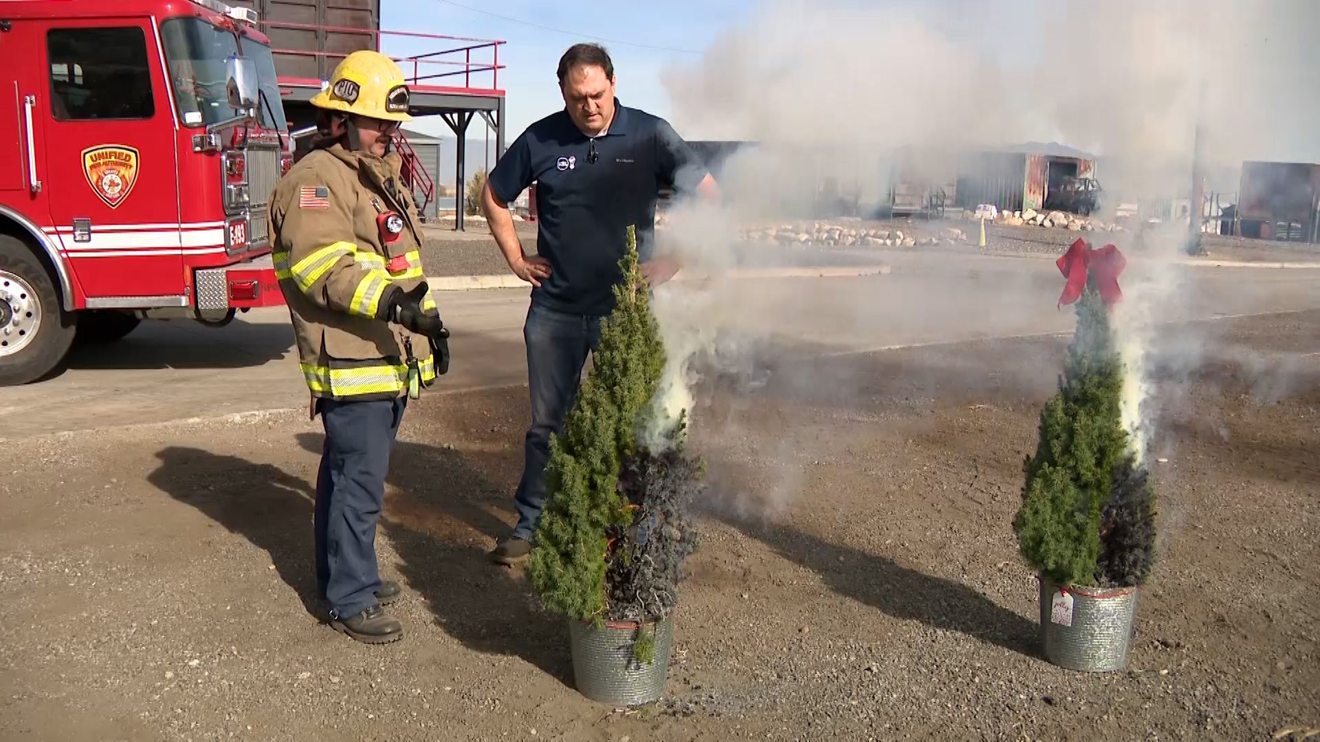 Firefighter Benjamin Porter of the Unified Fire Authority expresses surprise about how significantly faster this tree not watered burned compared to a tree watered regularly. (Mark Less, KSL TV)