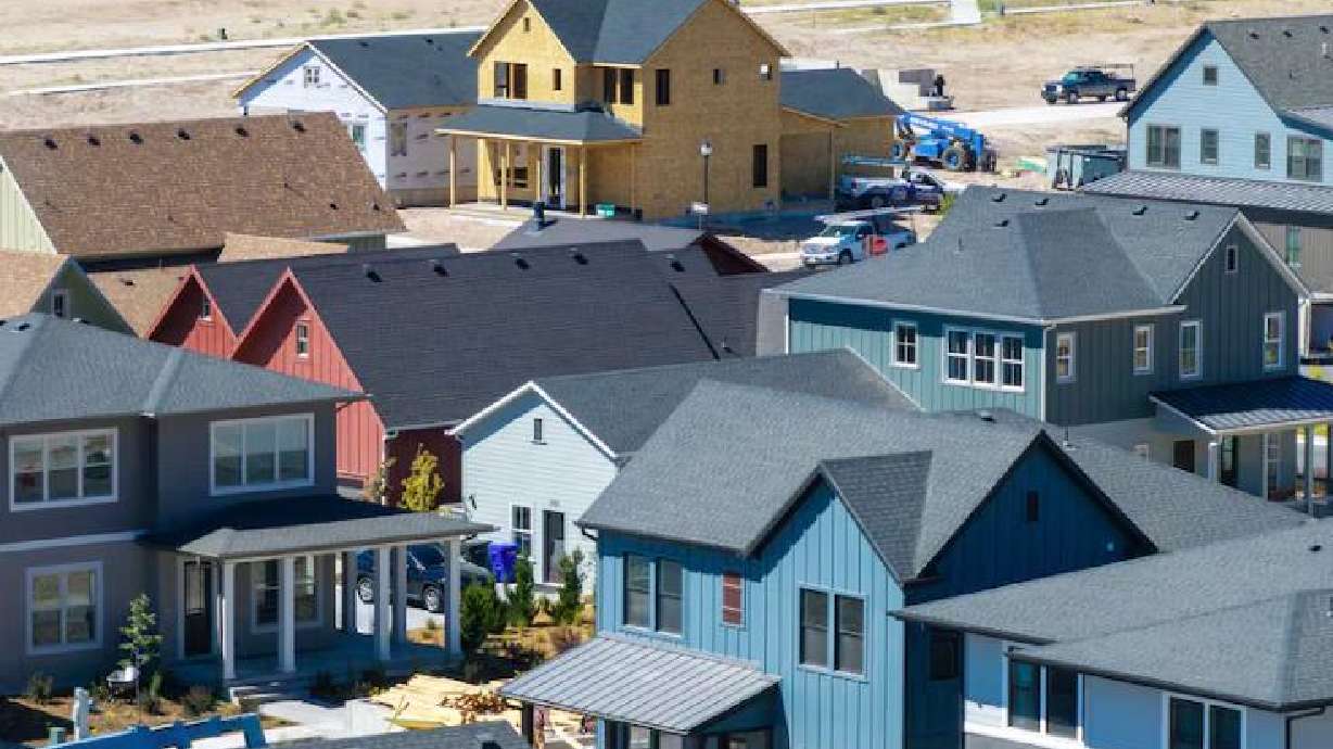 FILE: Workers build homes in West Jordan in this August 2025 photo. (Scott G Winterton, Deseret News)