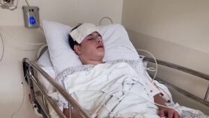 Ledger lies in a hospital bed after being hit in the face with a baseball. (Family photo)