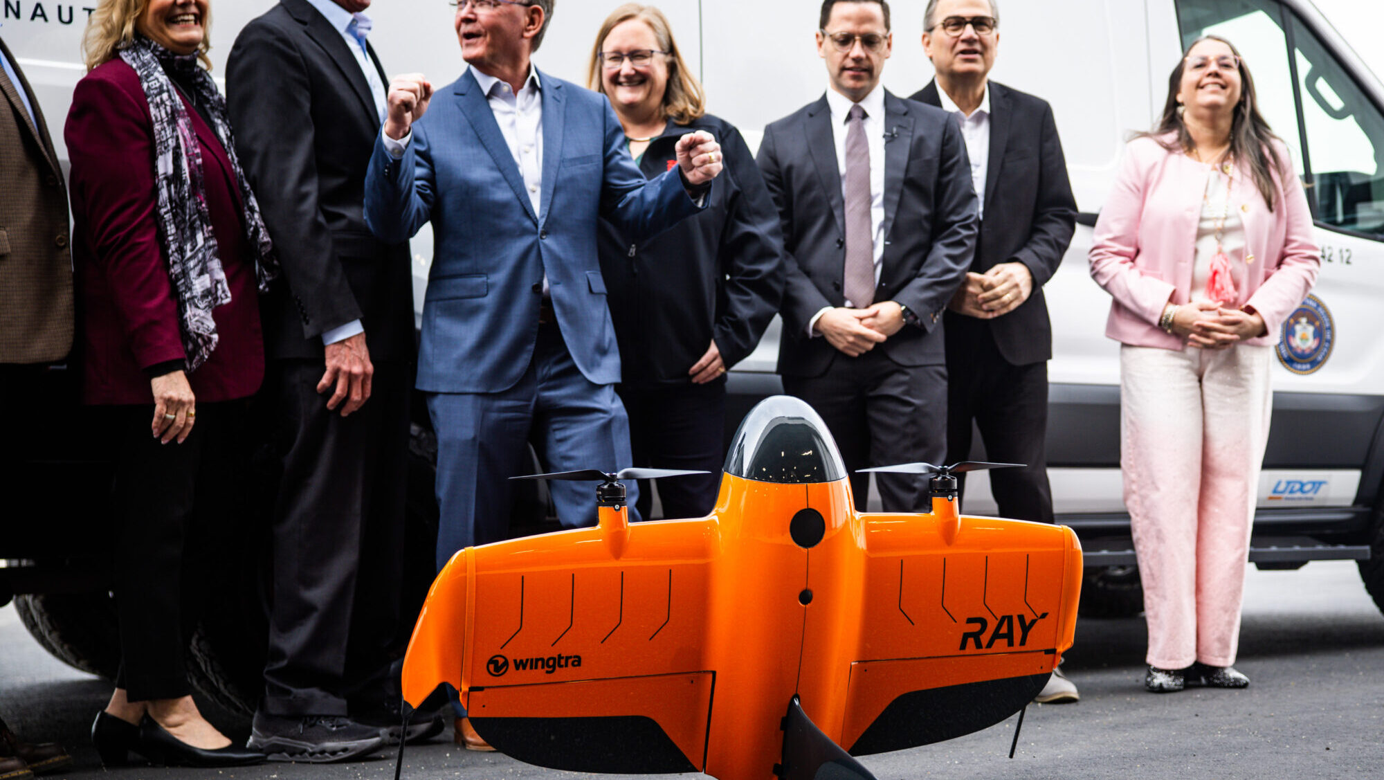 UDOT leadership and others gather for a photo behind a drone during a press conference to discuss UDOT’s selection to lead a federal pilot program testing advanced electric aircraft at the UDOT hangar at the Salt Lake City International Airport in Salt Lake City on Tuesday, March 10, 2026. (Tess Crowley, Deseret News)