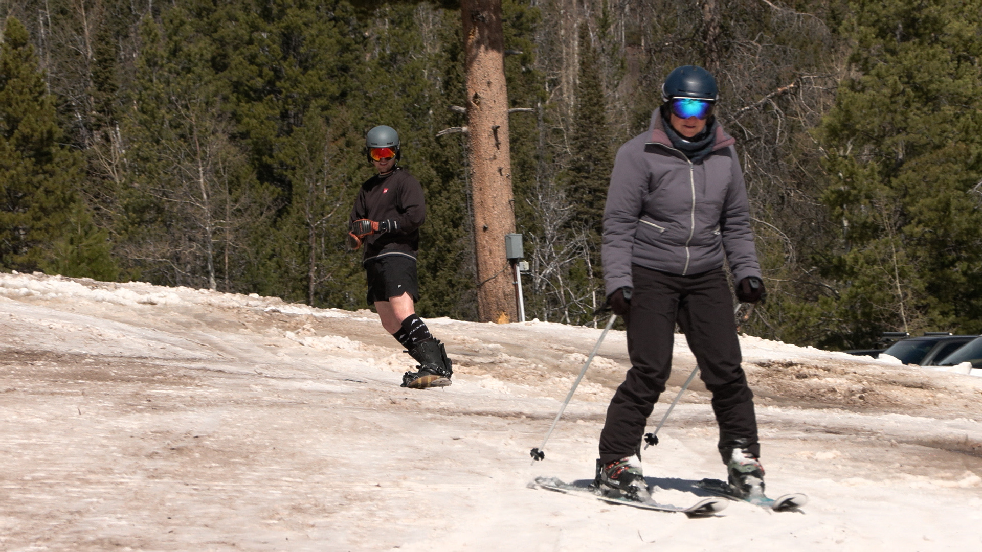 A skier and snowboarder ride through a thin base of slushy snow, Thursday. (Mike Anderson, KSL)