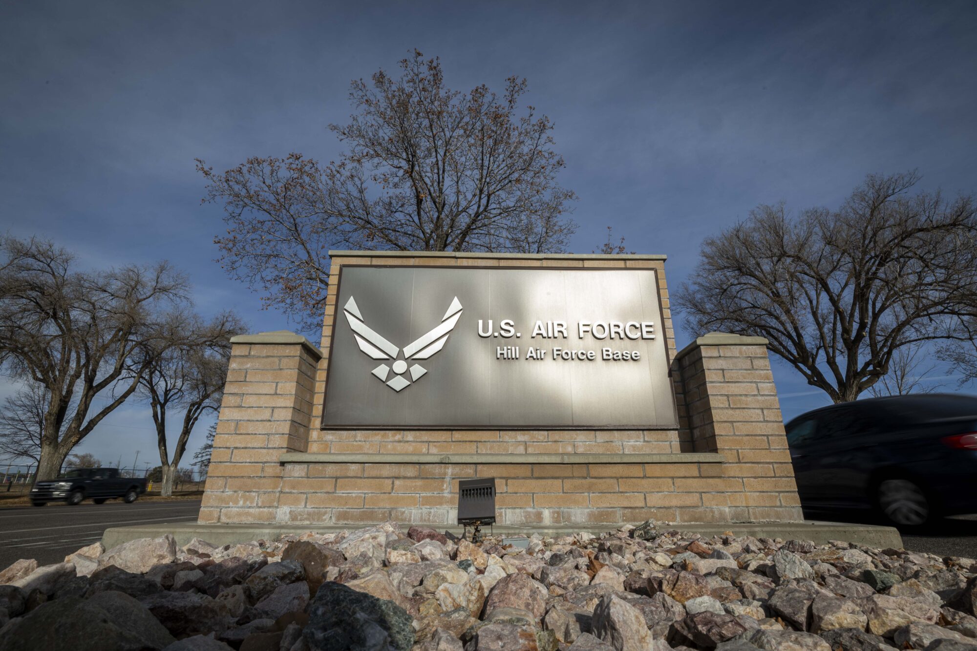 Traffic flows past a sign at the south gate of Hill Air Force Base northeast of Clearfield on Wednesday, Dec. 11, 2024. (Isaac Hale, Deseret News)