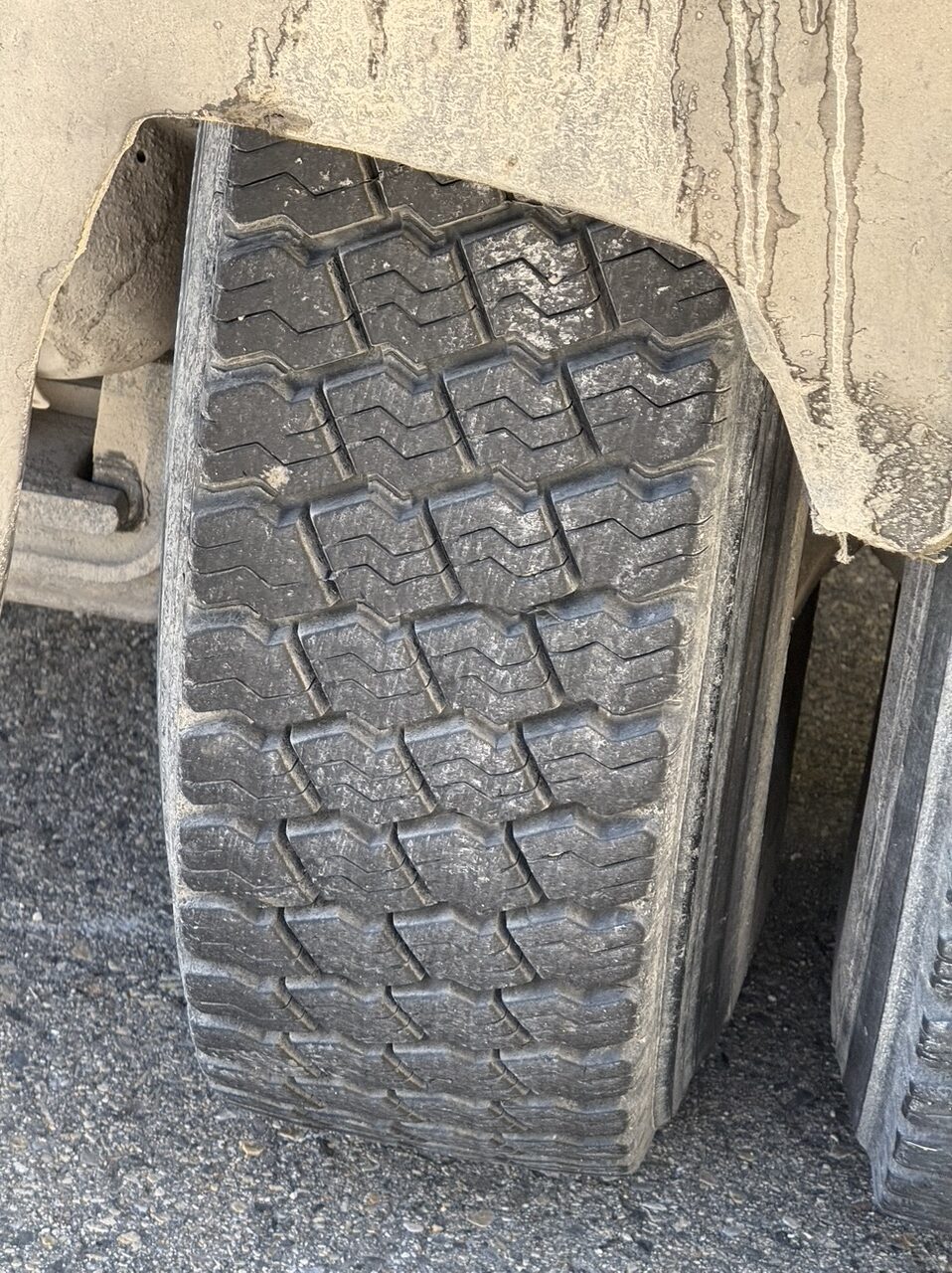 The dump truck's rear wheels show the worn mud flaps. (Philip Munoa)