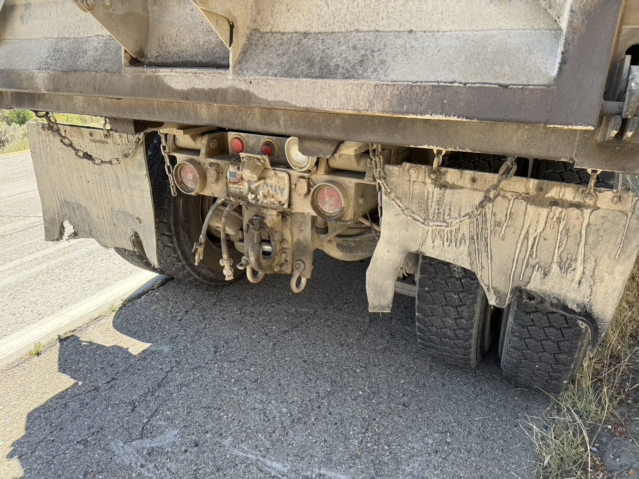 The dump truck's rear wheels show the worn mud flaps. (Philip Munoa)