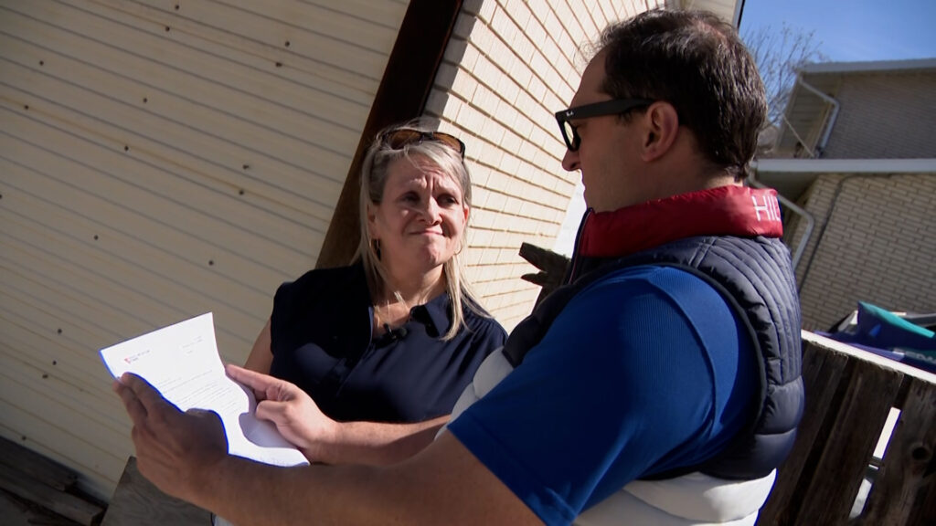 Susan Porter shows KSL's Matt Gephardt a demand letter from Rocky Mountain Power instructing her to move her garage. (Nathaniel Gillis, KSL)