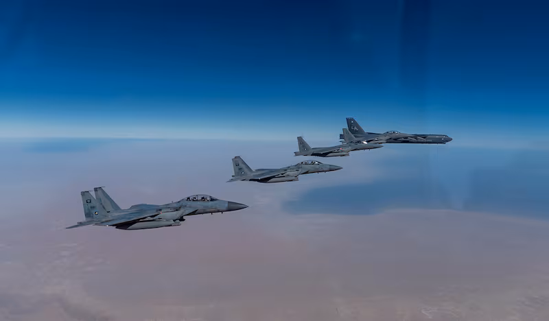 In this Wednesday, Jan. 27, 2021 handout photo, released by the U.S. Air Force, a B-52 bomber from the 2nd Bomb Wing of Barksdale Air Force Base in Louisiana, right, flies with Royal Saudi Air Force F-15s during a mission in the Middle East. (Senior Airman Roslyn Ward, U.S. Air Force via the Associated Press)