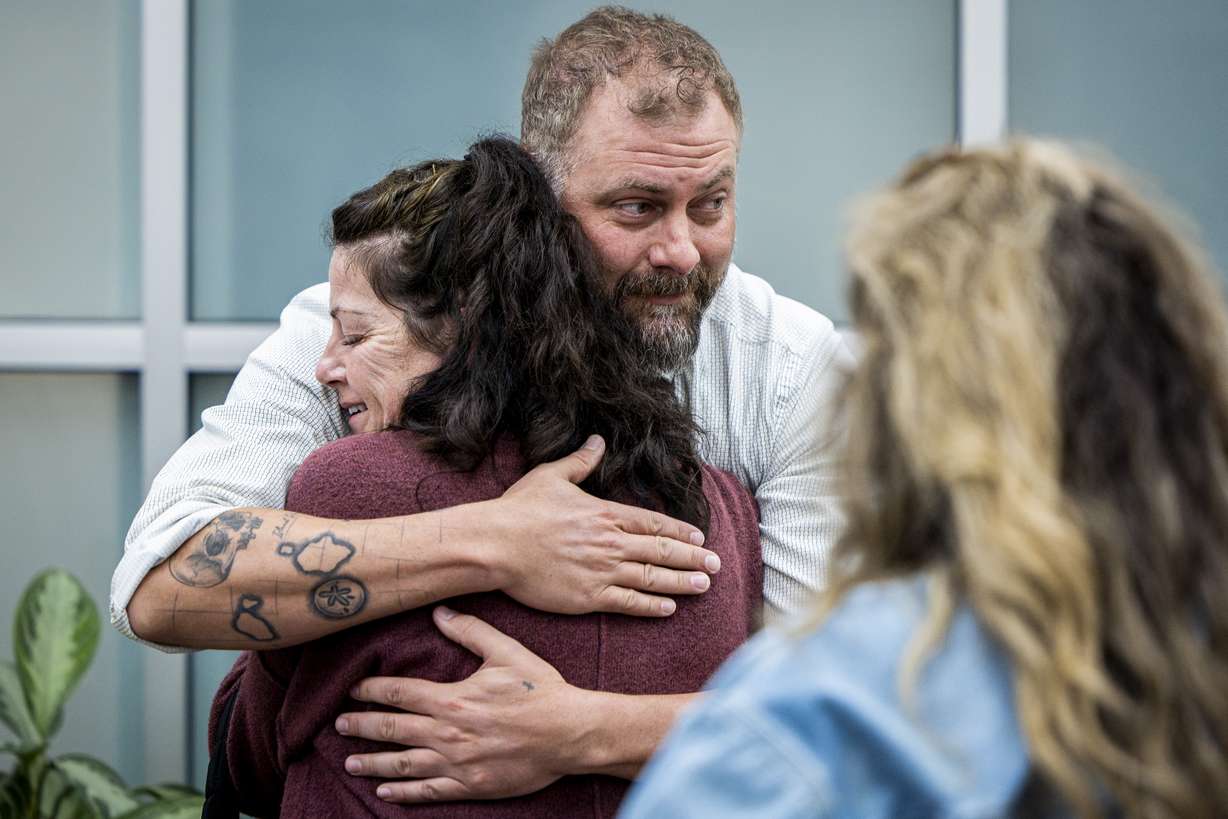 Utah County sheriff's detective Jake Hall looks to other family members as he hugs Tommi Aime, youngest sister of Laura Aime, after a press conference announcing definitive evidence has been found that Ted Bundy murdered Laura Ann Aime in 1974, held at the Utah County Sheriff's Office in Spanish Fork on Wednesday. (Isaac Hale, Deseret News)