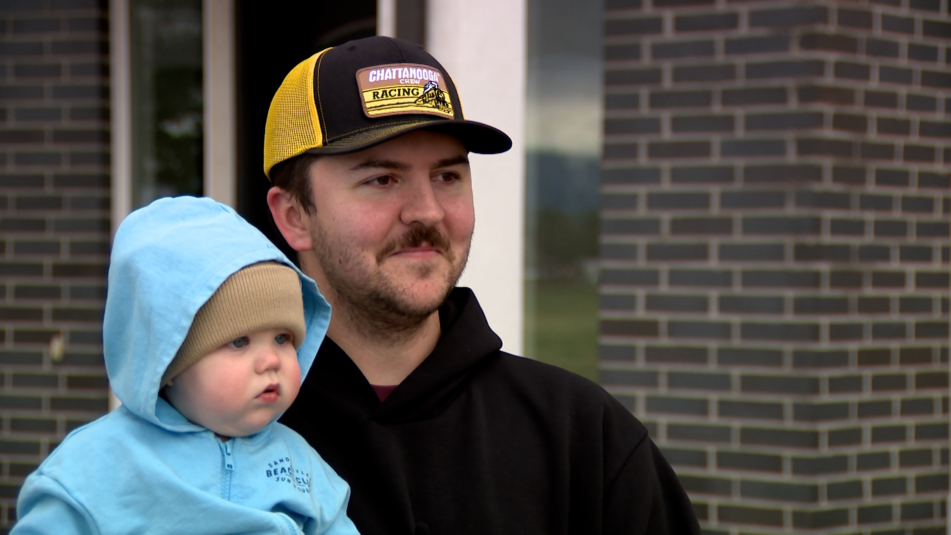 Braden Christensen speaks with KSL in Lehi while holding his son, Baker. (Wesley Barton, KSL)