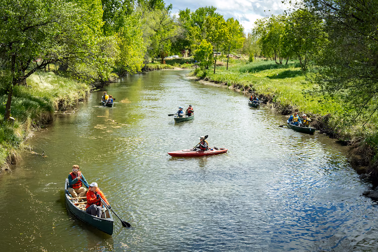 (Rick Egan | The Salt Lake Tribune) Volunteers paddle the Jordan River on Wednesday, April 22, 2026, as the Jordan River Commission hosted an Earth Day river cleanup.