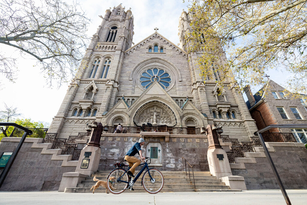 A cyclist rides past the Cathedral of the Madeleine with their dog after a mass for the late Pope Francis held at in Salt Lake City on Tuesday, April 22, 2025. (Isaac Hale, Deseret News)