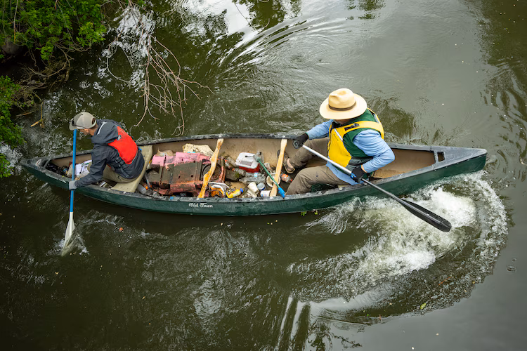 (Rick Egan | The Salt Lake Tribune) Sam Taylor and Carl Adams pick up trash along the banks of the Jordan River on Wednesday, April 22, 2026, as the Jordan River Commission hosted an Earth Day cleanup.