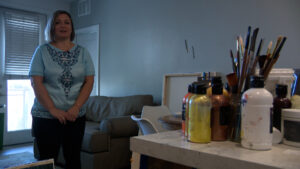 Olha Svieshnikova stands in her Sandy apartment near her art supplies on Friday, June 12, 2026. (Mark Less, KSL)