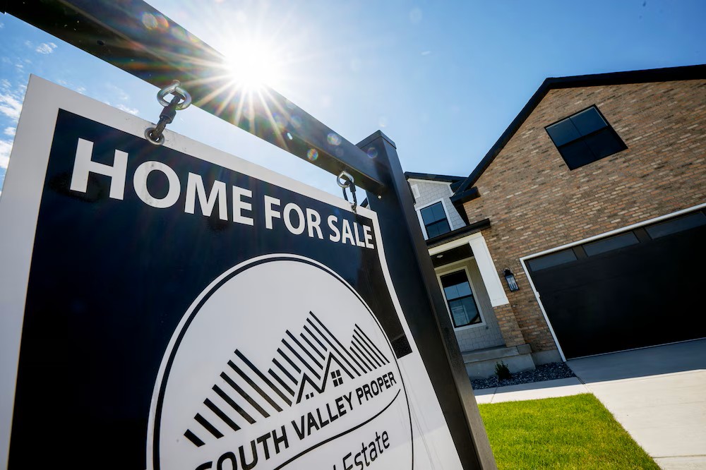 A for-sale sign stands in front of a home in West Jordan on Tuesday, May 12, 2026. (Scott G Winterton, Deseret News)